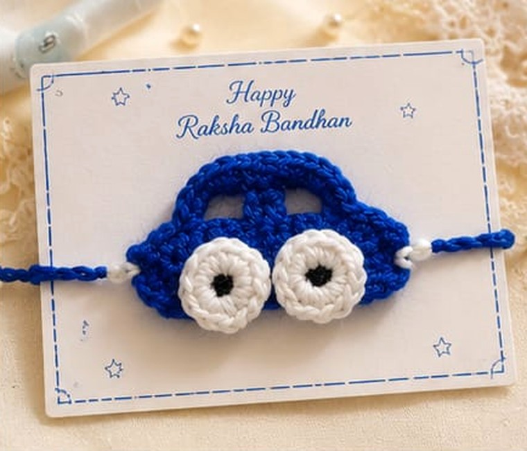 Handmade crochet blue car rakhi with white wheels