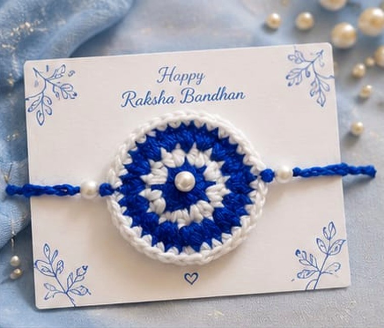Handmade crochet mandala rakhi in blue and white with pearl centre