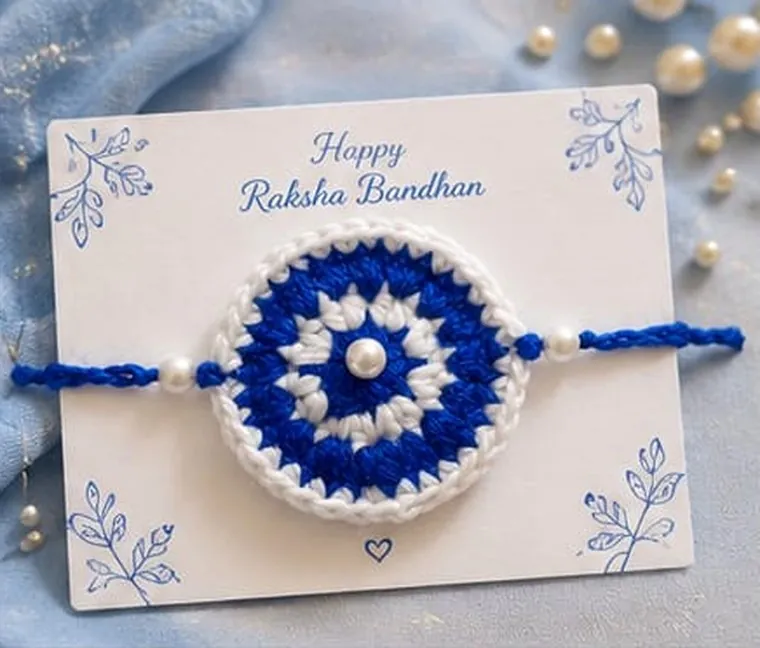 Handmade crochet mandala rakhi in blue and white with pearl centre