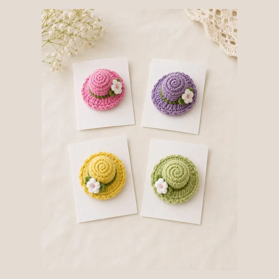 Handmade crochet mini sun hat hair pins with a small flower on the band, in four colours