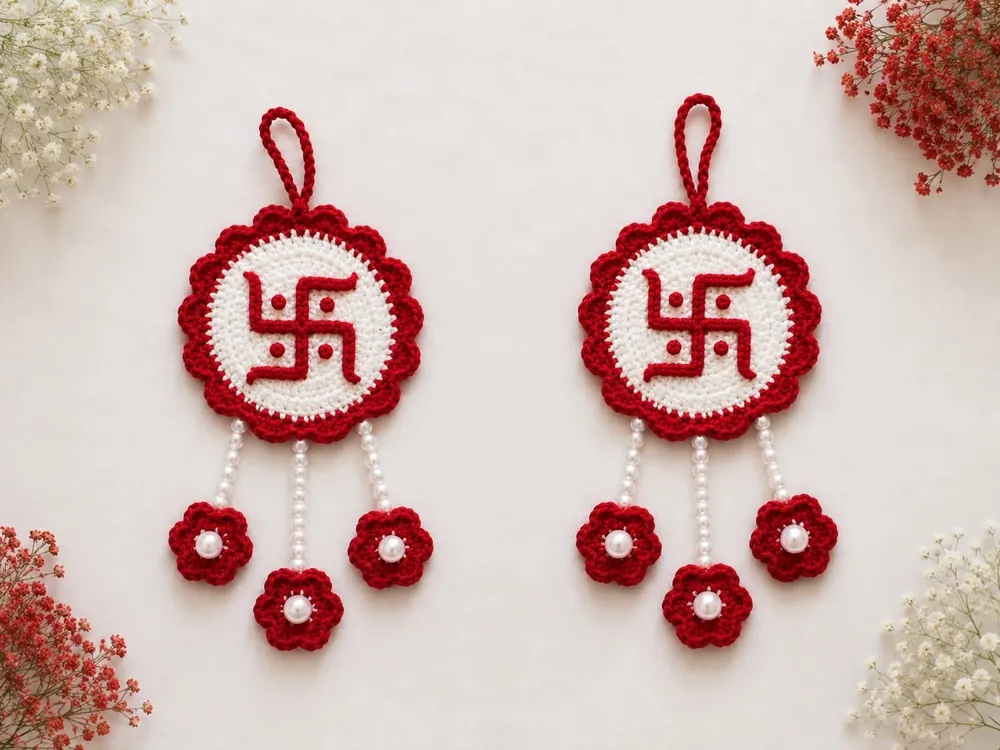 Pair of handmade crochet swastik wall hangings in red and white with pearl drops, by Crochet Craft