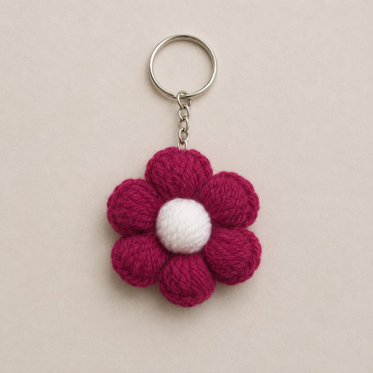 Handmade crochet magenta six-petal puff flower keychain with white centre