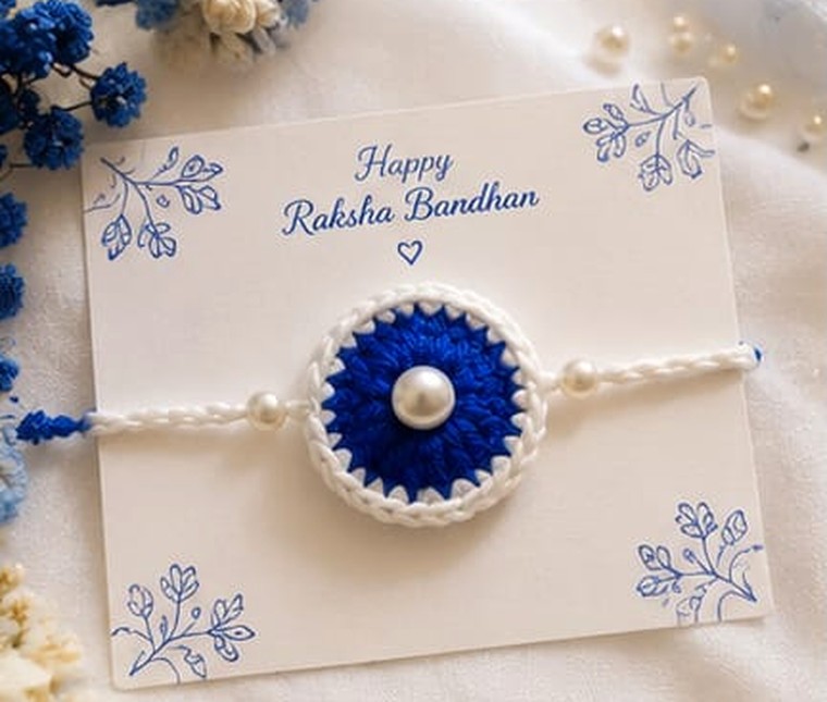 Handmade crochet rakhi in royal blue with white border and pearl beads